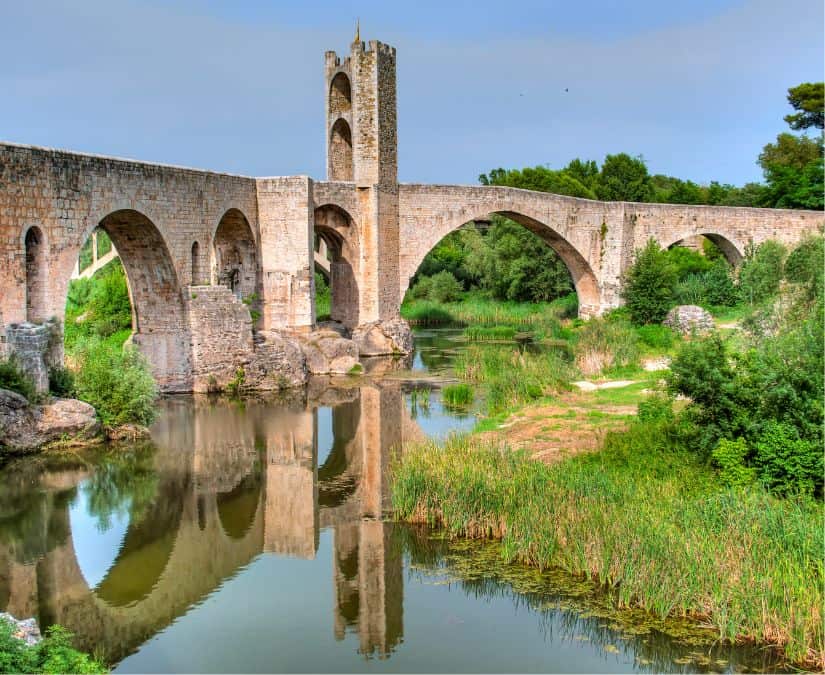 bridge with reflection in the water in besalu catalonia 